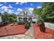 Charming single-story home featuring stone accents, a covered front porch, and professionally landscaped yard at 7710 Grove Hall Ave, Mint Hill, NC 28227
