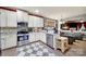 Modern kitchen featuring stainless steel appliances, light countertops, and a view into the living room at 7710 Grove Hall Ave, Mint Hill, NC 28227