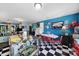Bright, quirky kitchen with black and white floors and retro-style dining area at 7710 Grove Hall Ave, Mint Hill, NC 28227