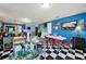 A bright eat-in kitchen featuring blue walls, an island prep-station and black and white tile floors at 7710 Grove Hall Ave, Mint Hill, NC 28227