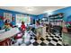 Eclectic kitchen featuring an eat-in dining area, black and white tile floors, and blue walls at 7710 Grove Hall Ave, Mint Hill, NC 28227