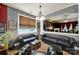 Well-appointed living room featuring leather seating, a large window, and decorative stone accent wall at 7710 Grove Hall Ave, Mint Hill, NC 28227