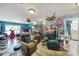 Fun living room with blue accent walls, plants, art, and comfortable seating at 7710 Grove Hall Ave, Mint Hill, NC 28227