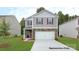 Charming two-story home with stone accents, a well-manicured lawn, and an attached two-car garage at 917 Two Brothers Ln, York, SC 29745