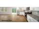 Open-concept kitchen with white cabinets, stainless steel appliances, and a sliding glass door at 917 Two Brothers Ln, York, SC 29745