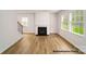 Living room with a cozy fireplace, hardwood floors, and large windows at 917 Two Brothers Ln, York, SC 29745