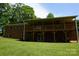 Brick home featuring a spacious covered porch with wooden railings and a lush green lawn at , Hickory, NC 28602