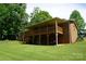 Brick home with a wooden porch overlooking a spacious, well-maintained yard at , Hickory, NC 28602