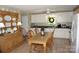 Bright kitchen and dining area featuring white cabinets and a charming wooden table at , Hickory, NC 28602