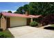 Charming brick home featuring an attached two-car garage and a vibrant red metal roof at , Hickory, NC 28602