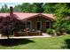 Inviting brick home with a red roof, a cozy front patio, and well-maintained landscaping at , Hickory, NC 28602