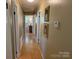 Hallway with wooden floors, wall art and access to various rooms at , Hickory, NC 28602