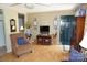 Charming living room featuring hardwood floors, a dark green door, and a cozy armchair at , Hickory, NC 28602