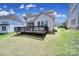 View of backyard with a deck, screened porch, and lush green lawn at 1001 Emory Ln, Fort Mill, SC 29708