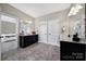 Stylish bathroom with double sinks, black cabinetry, tile floors, and two linen closets at 1001 Emory Ln, Fort Mill, SC 29708