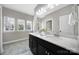 Bright bathroom featuring double sinks, black cabinetry, and tile floors at 1001 Emory Ln, Fort Mill, SC 29708