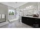 Bright bathroom featuring a glass shower, marble walls, and double sink vanity at 1001 Emory Ln, Fort Mill, SC 29708