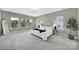 Bright bedroom featuring plush carpet, tray ceiling, neutral walls, and large windows at 1001 Emory Ln, Fort Mill, SC 29708