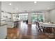 Open dining area with wood floors, view of kitchen, and sliding glass doors leading to screened porch at 1001 Emory Ln, Fort Mill, SC 29708