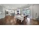 Bright dining area features wood floors, table setting, and views of modern kitchen at 1001 Emory Ln, Fort Mill, SC 29708
