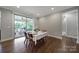 Dining room showcases wood floors, table setting, and sliding glass doors to porch at 1001 Emory Ln, Fort Mill, SC 29708