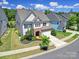Aerial view of a two-story home showcasing its manicured lawn, stone accents, and surrounding neighborhood at 1001 Emory Ln, Fort Mill, SC 29708