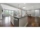 Bright kitchen with island, granite countertops, and an open layout that connects to the dining area at 1001 Emory Ln, Fort Mill, SC 29708
