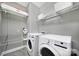 Functional laundry room with washer, dryer, and wire shelving for ample storage at 1001 Emory Ln, Fort Mill, SC 29708