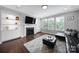 Cozy living room featuring a fireplace, built-in shelving, and large windows with natural light at 1001 Emory Ln, Fort Mill, SC 29708
