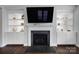 Living room boasts built-in shelves, a fireplace, and large screen television at 1001 Emory Ln, Fort Mill, SC 29708