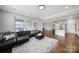 Open living space with wood floors, a comfortable sofa, and view to a modern kitchen at 1001 Emory Ln, Fort Mill, SC 29708