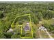 Aerial view of property featuring mature trees, home and detached garage outlined in yellow at 1001 Old Charlotte Rd, Concord, NC 28027