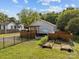 View of backyard with wooden fence, garden beds, and patio area with pergola at 1001 Old Charlotte Rd, Concord, NC 28027