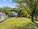 Expansive backyard featuring a spacious grassy area and a charming wooden fence at 1001 Old Charlotte Rd, Concord, NC 28027
