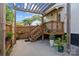 Cozy backyard patio with wooden staircase, string lights, and lush greenery at 1001 Old Charlotte Rd, Concord, NC 28027