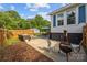Enjoy outdoor living with patio, fenced yard, dining set, and detached garage at 1001 Old Charlotte Rd, Concord, NC 28027