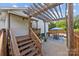 Backyard patio with wooden pergola, dining table, and outdoor furniture perfect for relaxation at 1001 Old Charlotte Rd, Concord, NC 28027