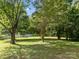 Lush backyard with mature trees offering shade and privacy at 1001 Old Charlotte Rd, Concord, NC 28027