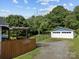 Spacious backyard featuring wooden pergola, fence, and detached garage at 1001 Old Charlotte Rd, Concord, NC 28027
