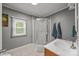 Bathroom with a shower and a single sink vanity with neutral colors at 1001 Old Charlotte Rd, Concord, NC 28027
