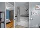 Bathroom featuring black-and-white shower, gray walls, and a glimpse into the adjacent bedroom at 1001 Old Charlotte Rd, Concord, NC 28027