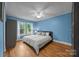 Spacious bedroom with hardwood floors, natural light, and updated light fixture at 1001 Old Charlotte Rd, Concord, NC 28027