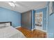 Bedroom with hardwood floors, built in shelving, and spacious wardrobe at 1001 Old Charlotte Rd, Concord, NC 28027