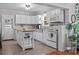 Bright kitchen with white cabinets, stainless steel sink, butcher block counters and kitchen island at 1001 Old Charlotte Rd, Concord, NC 28027