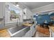 Bright kitchen with stainless steel sink, butcher block counters, and view to dining area at 1001 Old Charlotte Rd, Concord, NC 28027