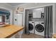 Laundry closet with modern appliances, located off the kitchen, next to the refrigerator at 1001 Old Charlotte Rd, Concord, NC 28027