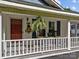 Charming front porch featuring a red door, seasonal decor, and rocking chairs at 1001 Old Charlotte Rd, Concord, NC 28027