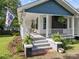 Inviting front porch with brick steps, white railing, rocking chairs, and manicured landscaping at 1001 Old Charlotte Rd, Concord, NC 28027