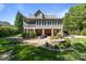 Expansive backyard features a stone patio, fire pit, outdoor grill, and lush landscaping, perfect for entertaining at 1002 4Th Ne St, Conover, NC 28613