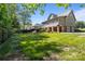 Large backyard with mature trees, stone patio, fire pit, outdoor grill, and attached garage at 1002 4Th Ne St, Conover, NC 28613